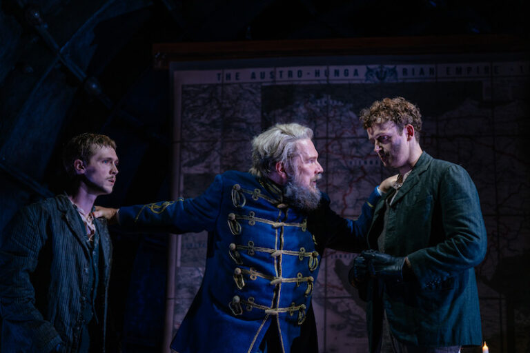 Marc stands in between Stanley and Christopher, with his hands on their chest