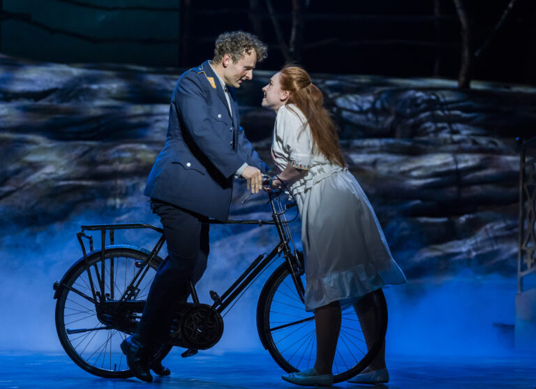 The Sound of Music – Leeds Grand Theatre A young man, Rolf, and a young woman, Liesl, almost kissing each other.