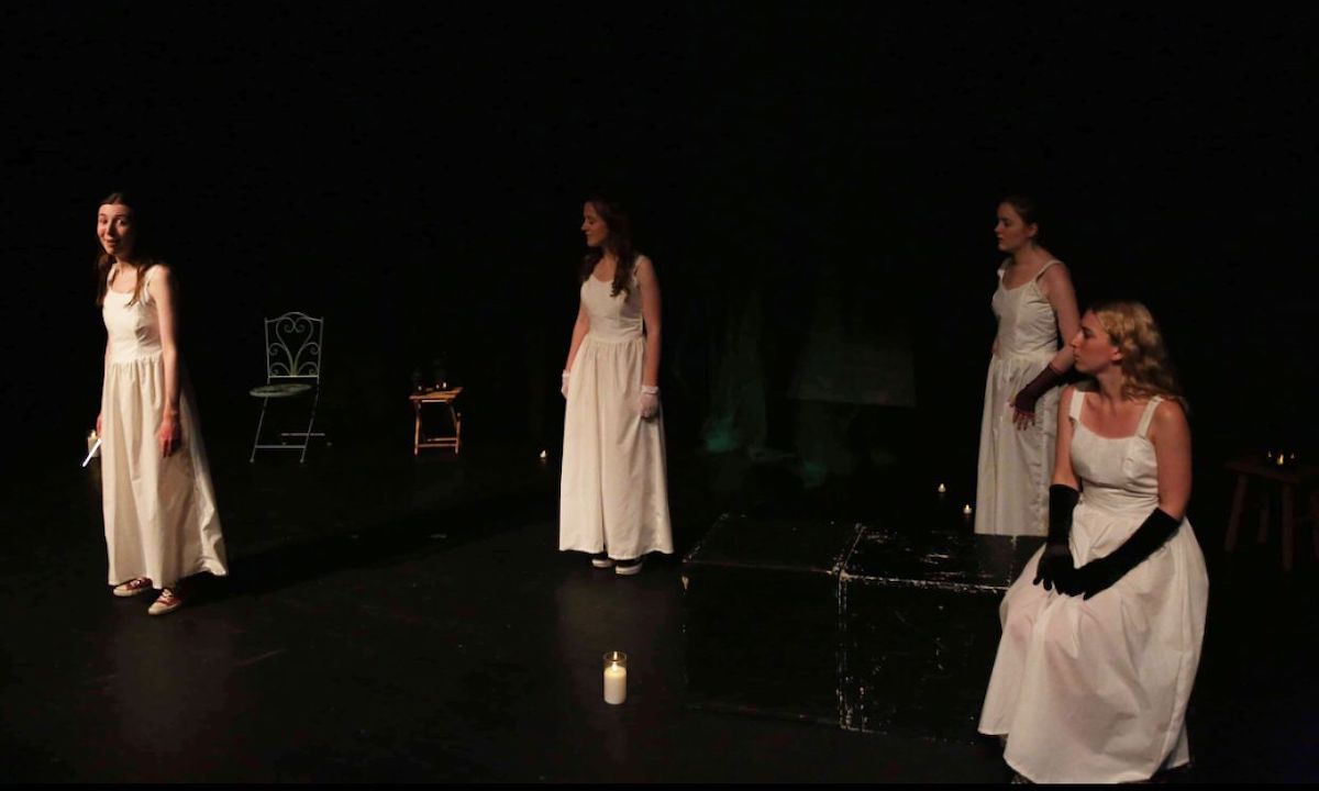 Four wowmwn are dressed in white against a black background